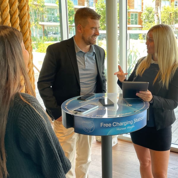 Three people having a conversation next to a Charging Table
